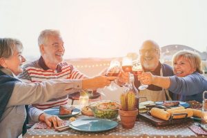 group of four eating dinner at the beach side