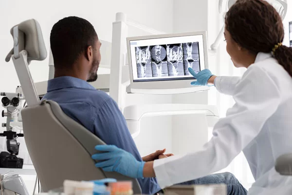 dentist showing patient his dental x-ray