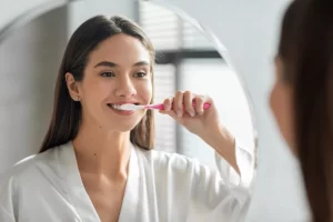 woman brushing her teeth