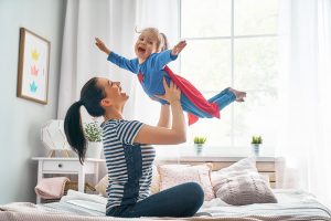 mother lifting her kid like superman