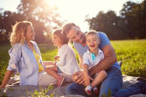 family of four sitting on the grass